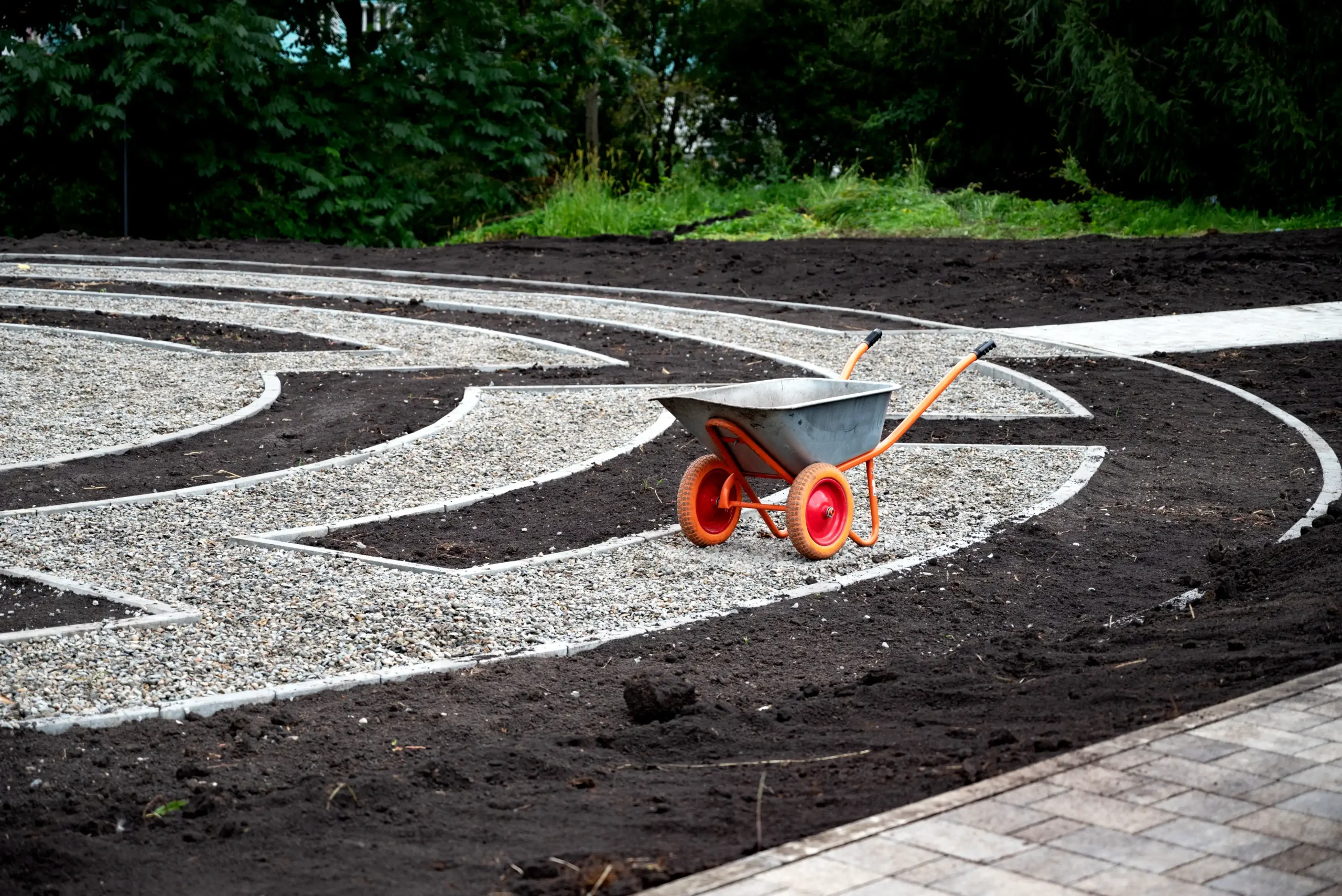 wheelbarrow on a landscaped garden pathway